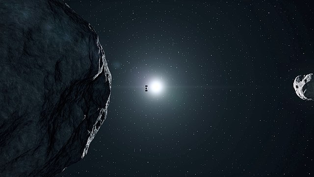 Photo of spacecraft Hera gliding past the asteroid Didymos